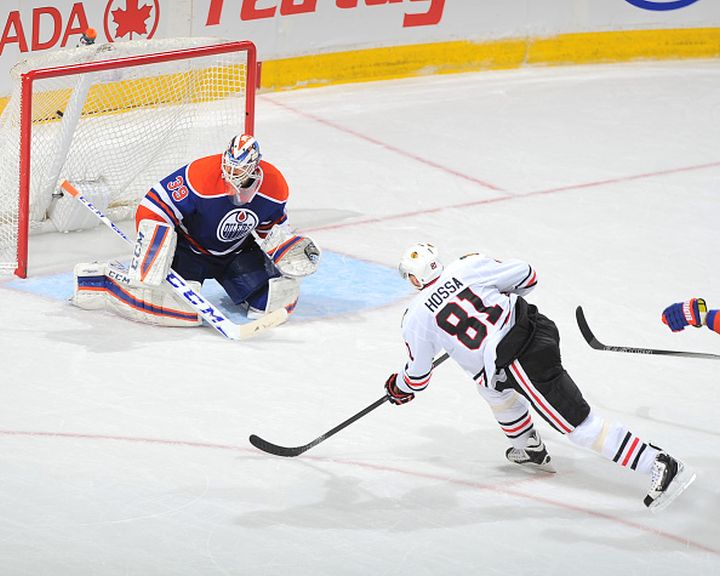 Marian Hossa #81 of the Chicago Blackhawks scores the game winning goal on Anders Nilsson #39 of the Edmonton Oilers on November 18, 2015 at Rexall Place in Edmonton, Alberta, Canada.