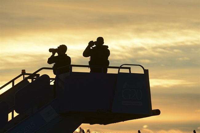 Security officials stand guard as they wait for the plane carrying US President Barack Obama to land in Antalya, Turkey, Sunday, Nov. 15 2015 for the G-20 summit. 