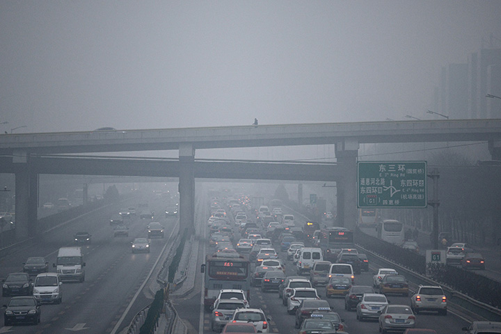 A man walks along an overpass amid heavy air pollution in Beijing on Dec. 8, 2015.