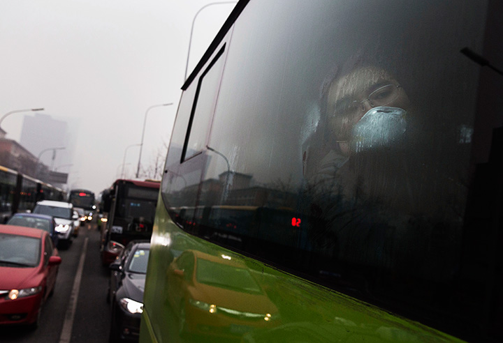 A man wears a mask to protect against pollution while commuting to work in heavy smog on December 8, 2015 in Beijing, China.