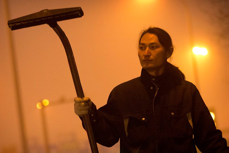Chinese artist Wang Renzheng demonstrates the use of his industrial shop-vac alongside a highway in Beijing, Tuesday, Dec. 1, 2015. Wang spent 4 hours per day for 100 days vacuuming the Beijing air with an industrial shop-vac, then baked the accumulated dust and pollutants into a brick. 
