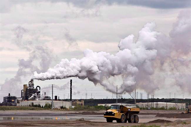 A dump truck works near the Syncrude oil sands extraction facility near the city of Fort McMurray, Alta.
