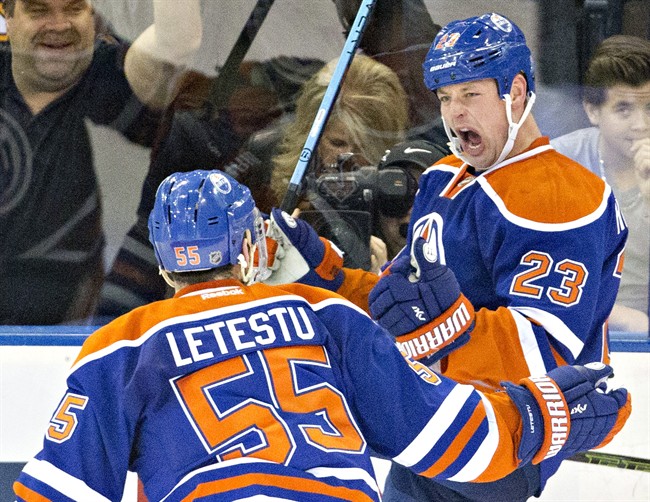 Edmonton Oilers' Matt Hendricks (23) and Mark Letestu (55) celebrate a goal against the Boston Bruins during second period NHL action in Edmonton, Alta., on Wednesday December 2, 2015.