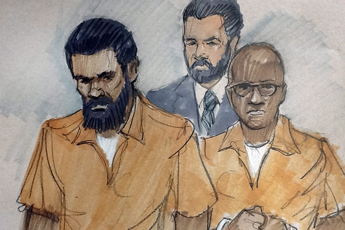 In this courtroom sketch, Jonas M. Edmonds, left, and Hasan R. Edmonds, right, stand in front of an FBI agent as they appear at a hearing at federal court in Chicago, Thursday, March 26, 2015,.