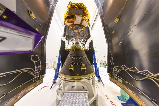 The Nov. 16, 2015 photo provided by European Space Agency ESA shows the LISA Pathfinder being encapsulated within the half-shells of the Vega rocket fairing on at the Centre Spatial Guyanais in Kourou, French Guiana.