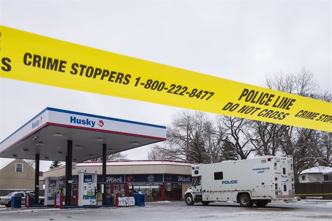 Homicide detectives investigate at a Mac’s convenience store in Edmonton on Friday, December 18, 2015.