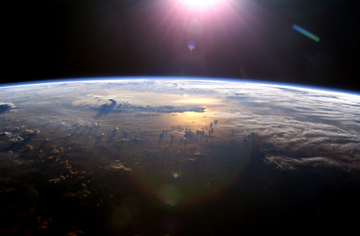 The sun illuminates Earth as seen from the International Space Station.