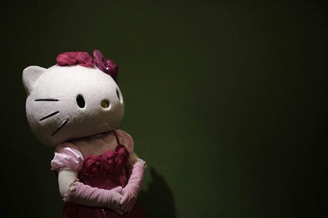 FILE - In this Thursday, Oct. 30, 2014 file photo, a model dressing as Japanese character Hello Kitty waits for guests to pose for a souvenir photo at Sanrio Puroland, a theme park featuring Hello Kitty in Tokyo. The Japanese company that owns the Hello Kitty brand said it has fixed a security leak in an online fan site for the famous character that compromised the personal information of 3.3 million users. Sanrio Co.’s digital arm said Tuesday, Dec. 22, 2015, that it “corrected” a security vulnerability on the SanrioTown.com website and was carrying out an investigation. The leak was discovered Saturday, Dec. 19, by a security researcher. 