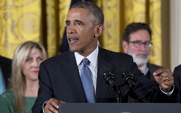 As tears flow from his eyes, President Barack Obama speaks in the East Room of the White House in Washington, about steps his administration is taking to reduce gun violence. 