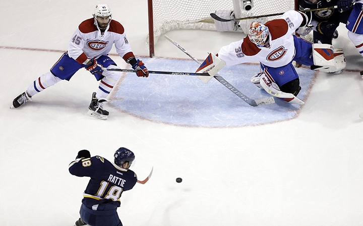St. Louis Blues' Ty Rattie scores past Montreal Canadiens goalie Mike Condon and Mark Barberio during the third period of an NHL hockey game Saturday, Jan. 16, 2016, in St. Louis. The Blues won 4-3 in overtime.