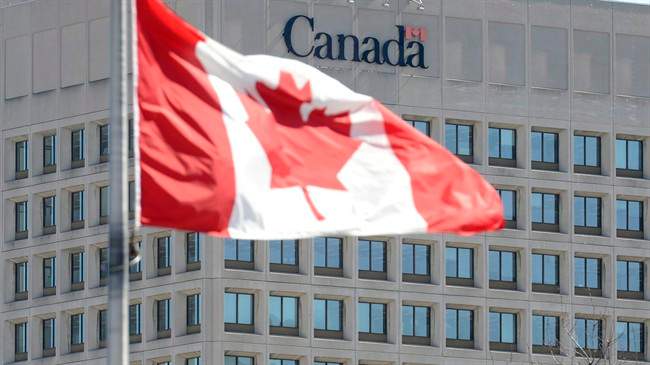 The facade of the headquarters of the Department of National Defense is pictured in Ottawa, on April 3, 2013. A sampling of the former Conservative government's planned military purchases shows two-thirds of the projects are behind schedule.
