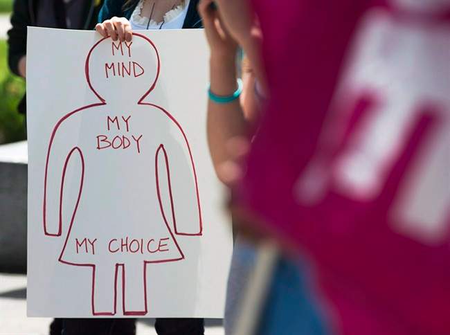 A protester holds a pro-choice sign at Victoria Park, in Halifax.