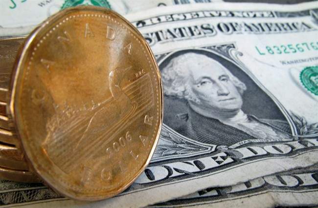 Loonies sit on an American dollar on Sept. 20, 2007 in Montreal. 