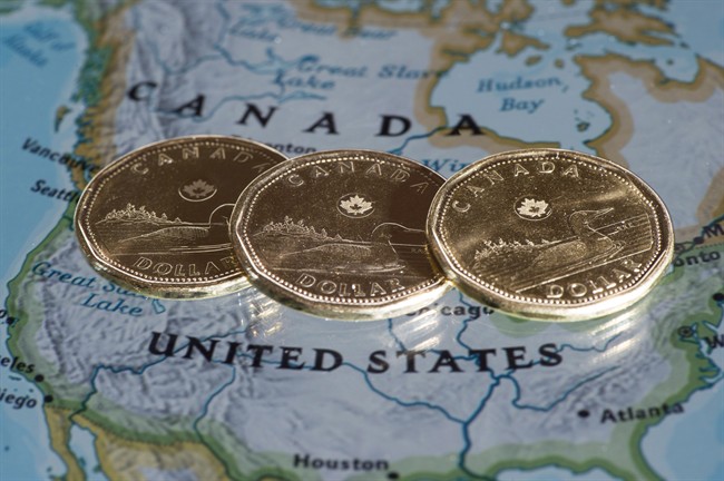 Canadian dollar coins are displayed on a map of North America on January 9, 2014 in Montreal. The Canadian dollar slipped below 70 cents U.S. on Wednesday for the second day in a row as the currency traded near lows set nearly 13 years ago.