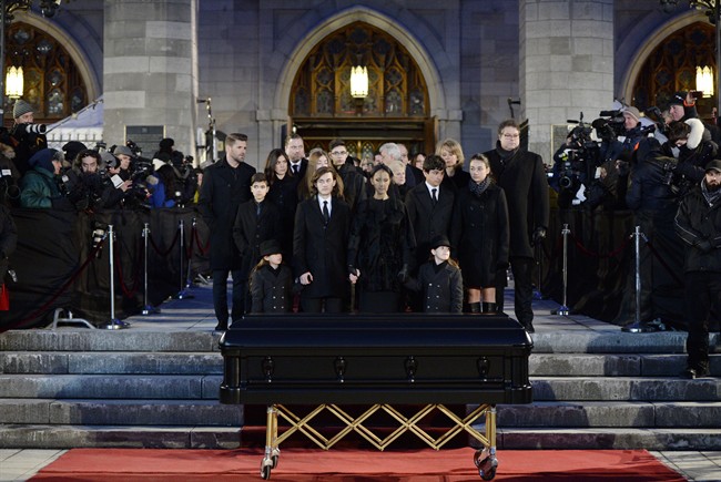Celine Dion, with sons Eddy and Nelson, and Rene-Charles Angelil, stand before her late husband Rene Angelil's casket at Montreal's Notre-Dame Basilica on Friday, January 22, 2016.