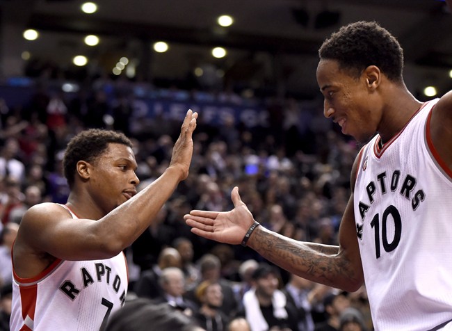 Toronto Raptors' DeMar DeRozan (10) and Kyle Lowry celebrate the dying seconds of their win over the Brooklyn Nets.
