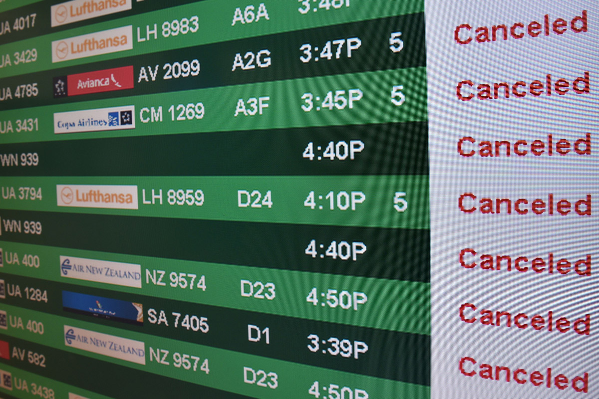 One of the flight status board for arrivals and departures is viewed at Dulles International Airport(IAD) just outside Washington, DC, January 22, 2016 in Sterling, Virginia.