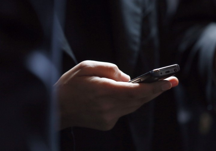 A file photo of a person holding a cell phone.
