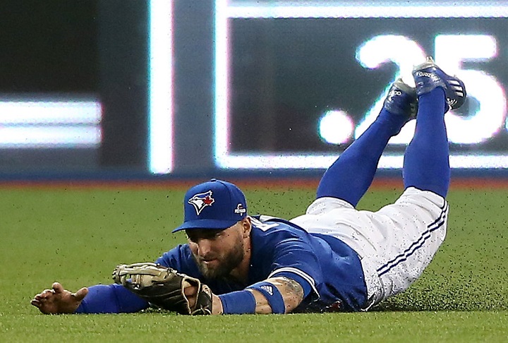 Kevin Pillar #11 of the Toronto Blue Jays makes a diving catch on a ball hit by Josh Hamilton #32 of the Texas Rangers in the fourth inning in game five of the American League Division Series at Rogers Centre on October 14, 2015 in Toronto, Canada. (Photo by Tom Szczerbowski/Getty Images).