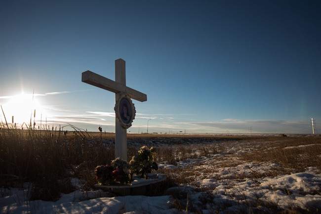 A memorial to a previous crash marks the intersection at Wanuskewin Rd and Highway 11, outside of Saskatoon. The intersection was the scene of tragedy where a family of four were killed in a collision with an SUV Sunday morning.