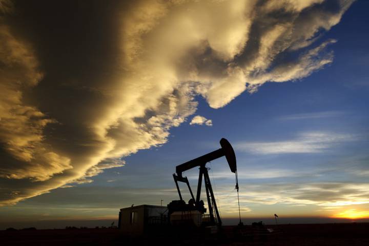 An oil pump owned by Cenovus extracts crude beneath a field in Alberta.