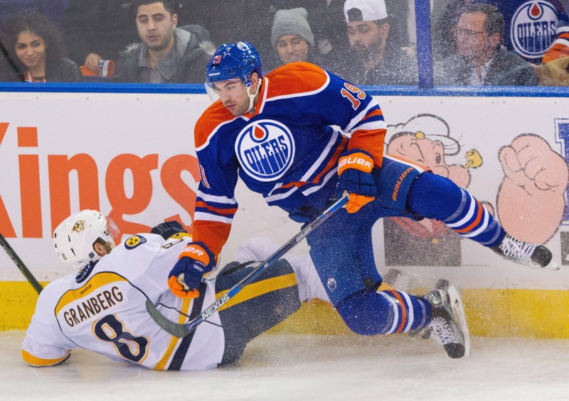 Nashville Predators' Petter Granberg (8) and Edmonton Oilers' Justin Schultz (19) collide during second period NHL hockey action in Edmonton, Alta., on Saturday January 23, 2016. THE CANADIAN PRESS/Amber Bracken.