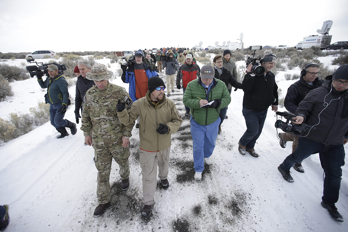 Members of the group occupying the Malheur National Wildlife Refuge headquarters, left, conduct a tour with the media Monday, Jan. 4, 2016, near Burns, Ore.