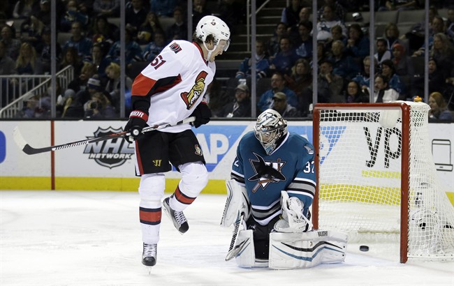 San Jose Sharks goalie Alex Stalock, right, is beaten for a goal on a shot from Ottawa Senators\’ Bobby Ryan, not seen, as Mark Stone (61) watches during the second period of an NHL hockey game Monday, Jan. 18, 2016, in San Jose, Calif.