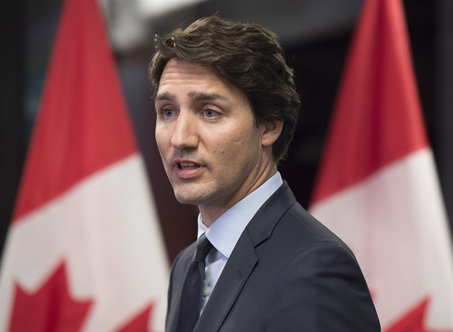 Prime Minister Justin Trudeau talks with reporters in Davos, Switzerland on Friday, Jan. 22, 2016. 