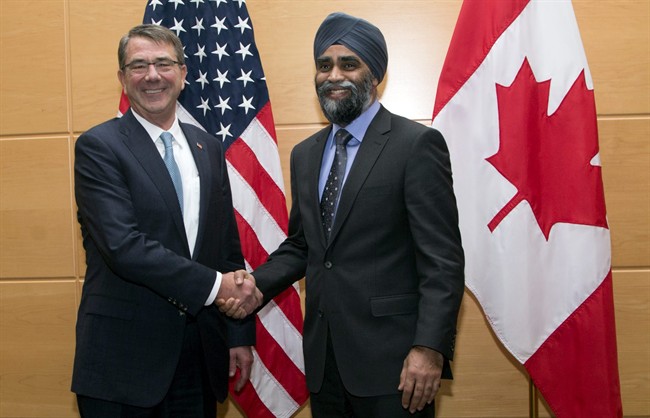 U.S. Secretary of Defense Ash Carter, left, shakes hands with Canadian Defence Minister Harjit Singh Sajjan prior to a bilateral meeting at NATO headquarters in Brussels on Wednesday, Feb. 10, 2016.