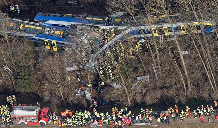 Firefighters and emergency doctors work at the site of a train accident near Bad Aibling, southern Germany, on February 9, 2016.