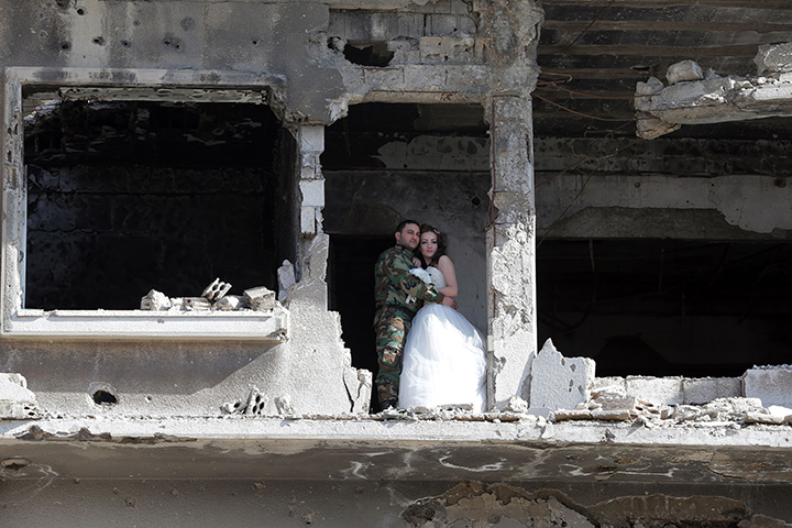 IN PHOTOS: Newlywed Syrian couple pose for wedding pictures amid ruins of war-ravaged city of Homs - image