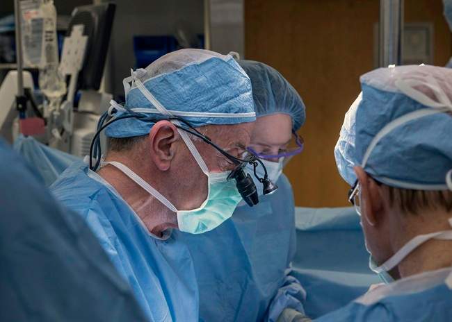 In this Wednesday, Feb. 24, 2016, photo provided by Cleveland Clinic Center, a team of Cleveland Clinic transplant surgeons and gynecological surgeons perform the nation’s first uterus transplant during a nine-hour surgery in Cleveland. In a statement Thursday, the Cleveland Clinic said the surgery was performed on a 26-year-old woman, using a uterus from a deceased donor. 