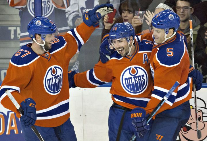 Edmonton Oilers' Benoit Pouliot (67), Jordan Eberle (14) and Mark Fayne (5) celebrate a goal against the Toronto Maple Leafs during third period NHL action in Edmonton, Alta., on Thursday February 11, 2016. 