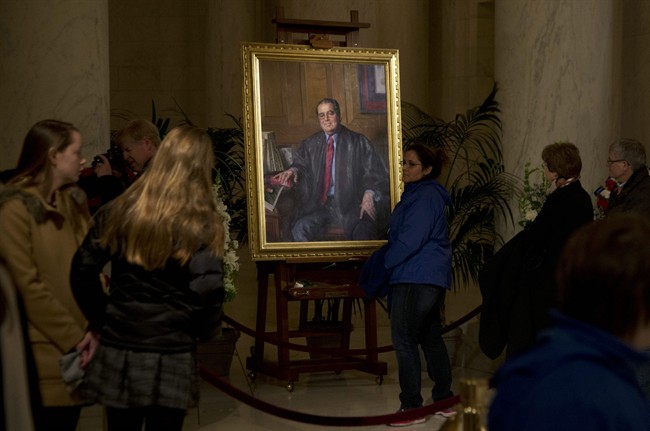 FILE - In this Feb. 19, 2016 file photo, people line up to pay their respect to the late Justice Antonin Scalia in the Great Hall of the Supreme Court in Washington, where Scalia's body lies in repose. A letter from the Supreme Court's doctor said Scalia suffered from coronary artery disease, obesity and diabetes, among other ailments that probably contributed to the justice's sudden death.