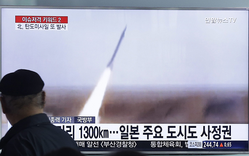 A man watches a TV screen showing a file footage of the missile launch conducted by North Korea, at Seoul Railway Station in Seoul, South Korea, Friday, March 18, 2016.  