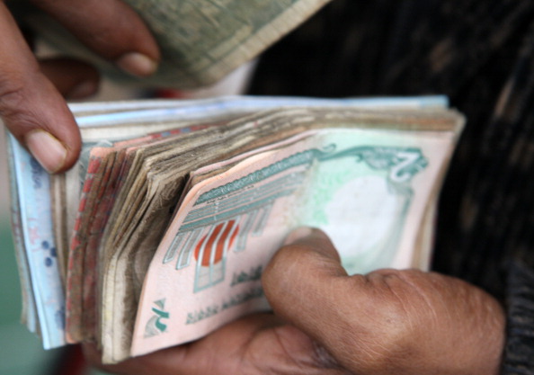 A vender counts bank notes at a market in Dhaka, Bangladesh, on Monday, Jan. 9, 2012. 