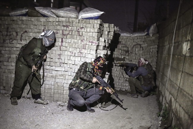 In this photo dated Thursday Feb. 25, 2016, militants of Kurdistan Workers' Party, PKK, move to attack Turkish security forces in Nusaybin, south Turkey, Thursday, Feb. 25, 2016.
