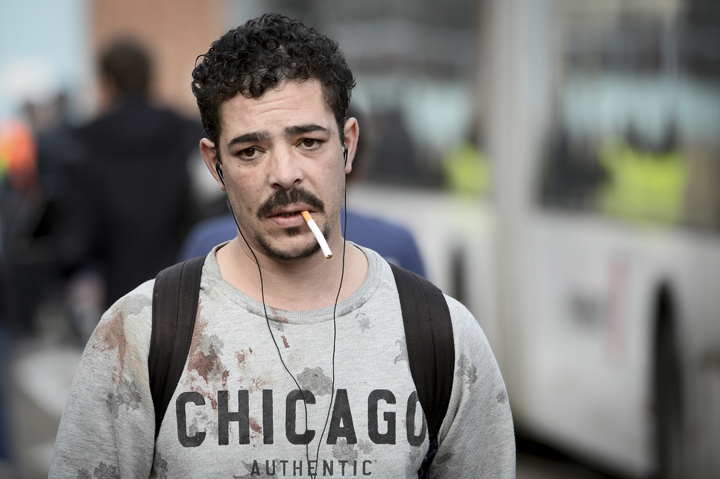 A man with blood stains on his sweater leaves Brussels airport in Zaventem on March 22, 2016 following twin blasts. 