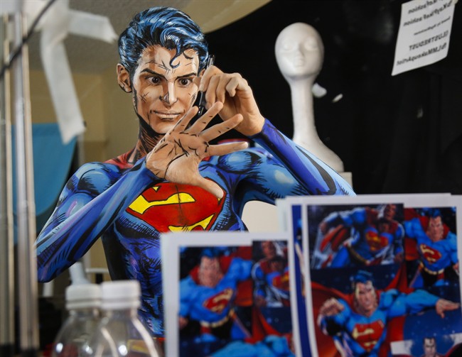 Over a 12 hour period, all the while live streaming on the internet, Kay Pike transforms herself using body paint and latex into Superman at her home in Calgary, Alta., Saturday, March 19, 2016.