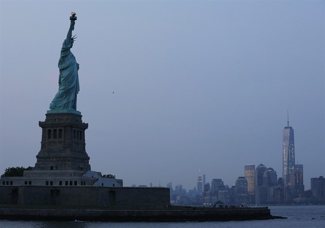In this Tuesday, July 7, 2015, file photo, the Statue of Liberty stands in New York harbor with the New York City skyline in the background.