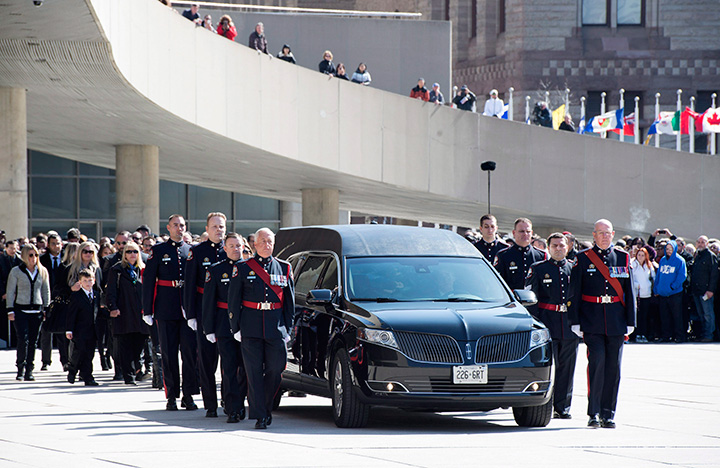 Pallbearers carry the casket of former Toronto mayor Rob Ford from city hall during his funeral procession to St. James Cathedral in Toronto on Wednesday, March 30, 2016.