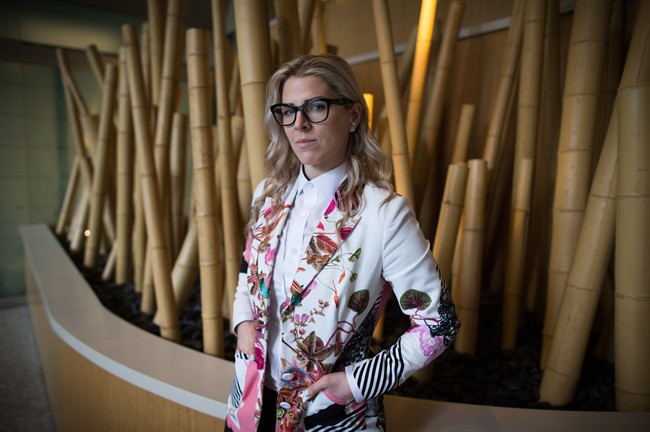 Former WestJet flight attendant Mandalena Lewis stands for a photograph in Vancouver, B.C., on Tuesday March 8, 2016. Lewis, fired after reporting an alleged sexual assault by one of the airline's pilots, says she is shocked at the positive response she's received since sharing her story publicly.