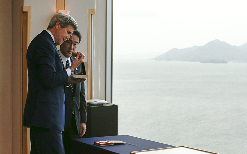 US Secretary of State John Kerry takes a look at a pocket watch as Japanese Minister for Foreign Affairs Fumio Kishida looks on during their bilateral talks prior to the second-day of the Group of Seven countries' foreign ministers meeting in Hiroshima,  Japan on April 11 2016. 