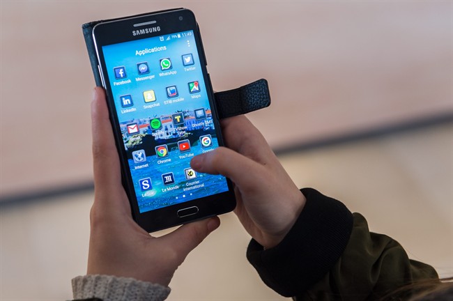 A woman uses an Android smartphone .