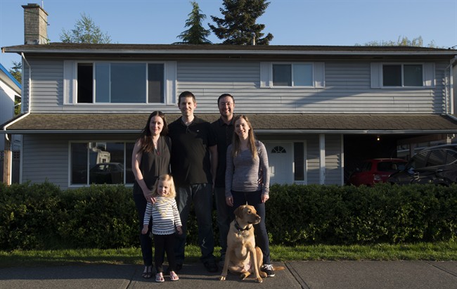 Jeremy Campbell along with his fiancee Holly Foran and dog Jake, right, shown in Delta, B.C., Monday, April, 25, 2016, bought a house together with Ryan and Christina Ingham and their two-year-old Regan. 