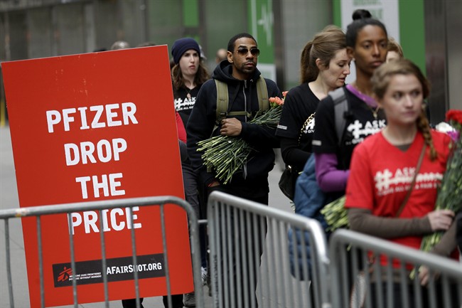 Activists line up to put flowers in crib in front of Pfizer world headquarters in New York, Wednesday, April 27, 2016. The crib filled with flowers, organized by Doctors Without Borders, was delivered to Pfizer with a petition demanding that the pharmaceutical company lower the cost of the pneumonia vaccine.