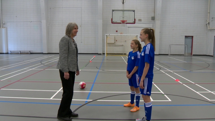 U of C researcher Carolyn Emery with Calgary sisters Emma and Myla Schneider.