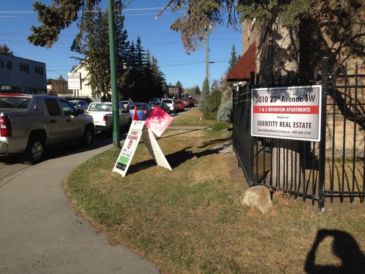 Street cleaning sign on southwest Calgary street corner