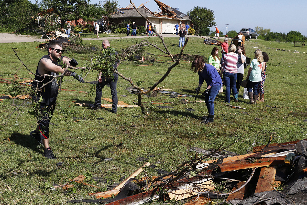 Stephen Goldstein, left, helps other volunteers pick up debris on Stark Lane in Sherman, Texas on Wednesday, April 27, 2016.